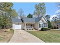 Quaint single-Gathering home featuring an attached garage, inviting front porch, and manicured landscaping for great curb appeal at 105 Damask Rose Dr, Holly Springs, NC 27540