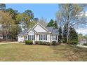 Well-maintained single-story residence with a classic design, including an attached garage and a welcoming covered front porch at 105 Damask Rose Dr, Holly Springs, NC 27540