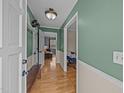 Inviting home hallway showcasing hardwood floors and neutral paint at 1208 Briarcliff Rd, Burlington, NC 27215