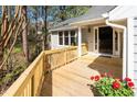 Spacious wooden front porch featuring a stylish railing, providing a warm welcome to the home at 124 Ripley Ct, Cary, NC 27513