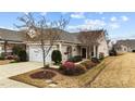 Charming one-story home with attached garage and beautifully landscaped front yard at 1404 Palmer Hill Dr, Durham, NC 27703
