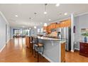 Spacious open kitchen with breakfast bar, granite countertops, and stainless steel appliances at 1404 Palmer Hill Dr, Durham, NC 27703