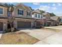 Attractive townhomes with brick accents, manicured landscaping, and paved driveways on a sunny day at 150 Alamosa Pl, Cary, NC 27519