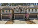 Lovely townhome featuring gray siding, a brick-accented garage, and beautiful flowering trees at 150 Alamosa Pl, Cary, NC 27519