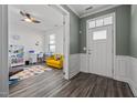 Inviting foyer with wood-look floors and a view into the playroom through a doorway at 1527 Ingraham Dr, Apex, NC 27502