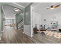 Hallway view with wood floors, neutral paint, stairs, and an arched doorway at 1527 Ingraham Dr, Apex, NC 27502
