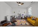 Bright playroom with a ceiling fan, colorful rug, and storage at 1527 Ingraham Dr, Apex, NC 27502