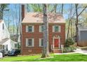 Beautiful brick home with a well-manicured lawn and classic architectural details at 202 Lighthouse Way, Cary, NC 27511