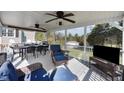 Spacious covered deck with ceiling fans, comfortable seating, and an outdoor dining area at 206 Herronwood Dr, Graham, NC 27253