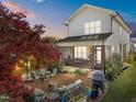 Relaxing backyard with a stylish brick patio, comfortable seating, and lush landscaping at 207 Grand Ave, Raleigh, NC 27606