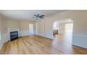Bright living room with a cozy fireplace and modern wood-look flooring, connecting to the kitchen at 210 Holloway Rd, Roxboro, NC 27573