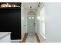 Bright hallway with light gray walls and hardwood floors, leading to various rooms at 2133 Persimmon Ridge Dr, Raleigh, NC 27604