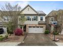 Charming two-story home with stone accents, a two-car garage, and a basketball hoop in the front yard at 219 Begen St, Morrisville, NC 27560