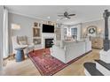Bright living room featuring a decorative fireplace, plush seating, and hardwood floors at 2340 Florida Ct, Raleigh, NC 27615