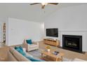 Inviting living room with a fireplace, neutral-toned furniture, and a vaulted ceiling at 24 High Standard Ln, Angier, NC 27501