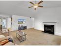 Inviting living room with high ceilings, ceiling fan, a fireplace and large windows at 24 High Standard Ln, Angier, NC 27501