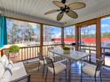 Comfortable screened porch with wood flooring, ceiling fan and outdoor seating at 24 High Standard Ln, Angier, NC 27501