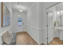Inviting entryway features wood floors, neutral decor, and a half bathroom, seamlessly blending style with functionality at 242 Luftee Ln, Holly Springs, NC 27540