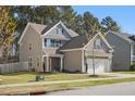Attractive two-story home with a well-kept lawn and attached two-car garage, showcasing curb appeal at 250 Hawksbill Dr, Franklinton, NC 27525