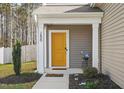 A closer view of the home's entryway with a bright yellow front door at 250 Hawksbill Dr, Franklinton, NC 27525