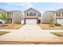 Charming two-story home with a two car garage, brick accents, manicured lawn, and a beautiful flower bed at 2512 Lily Dr, Haw River, NC 27258