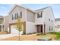 Charming two-story home with a combination of brick and siding, complemented by a well-manicured lawn at 2512 Lily Dr, Haw River, NC 27258