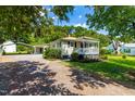 Cozy one-story home with a covered front porch, an adjacent carport, and a gravel driveway at 2616 Bullock Rd, Durham, NC 27704