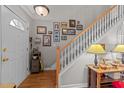 Inviting foyer featuring a staircase, wood floors, and stylish decor at 2825 Alder Ridge Ln, Raleigh, NC 27603
