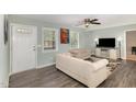 Cozy living room with wood-look floors, neutral paint, and lots of natural light at 297 Lane Store Rd, Franklinton, NC 27525