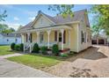 This home has a quaint front porch and lush landscaping at 309 W Parrish Dr, Benson, NC 27504