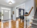 Inviting foyer with hardwood floors, a staircase, and view to dining room at 3100 Anderson Dr, Raleigh, NC 27609