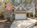 Charming home featuring a large garage, stone accents and a covered carport at 311 Lilliput Ln, Wake Forest, NC 27587