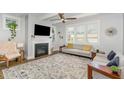 Bright living room with a fireplace, large windows, and elegant furniture at 332 Tumbling River Dr, Wendell, NC 27591
