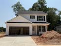 Two-story home with white siding, black shutters and an attached two-car garage at 35 Fetterbush Way, Clayton, NC 27520