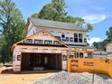 New construction two-story home with attached two-car garage featuring contemporary design details at 35 Fetterbush Way, Clayton, NC 27520