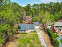 Scenic aerial view of a beautiful home nestled among lush greenery and mature flowering trees at 4012 Old Sturbridge Dr, Apex, NC 27539
