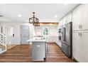 Modern kitchen features an island, stainless steel appliances, and stylish pendant lighting at 4012 Old Sturbridge Dr, Apex, NC 27539