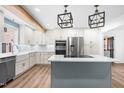 Beautiful kitchen features stainless steel appliances, white cabinets, and a large center island at 4012 Old Sturbridge Dr, Apex, NC 27539