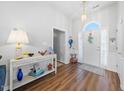 Bright foyer with wood floors, chandelier and a decorative table at 406 Southshore Pkwy, Durham, NC 27703