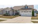Charming home featuring a two-car garage, well-maintained lawn, and inviting curb appeal at 428 Beaverdam Lake Dr, Fuquay Varina, NC 27526
