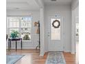 Bright foyer featuring hardwood floors, a decorative rug, and a view to the outside at 428 Beaverdam Lake Dr, Fuquay Varina, NC 27526