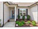 Inviting front entrance with a beautifully decorated door and well-manicured landscaping at 428 Beaverdam Lake Dr, Fuquay Varina, NC 27526