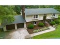 Aerial view of home showcasing manicured lawn, multi-car driveway, and attached garage at 4508 Old Us 421 N, Siler City, NC 27344