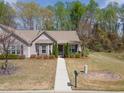 An aerial shot shows a home in a peaceful neighborhood setting, surrounded by mature trees and lawns at 469 Winding Wood Dr, Clayton, NC 27520