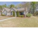 Home with tidy landscaping, side shed, and a walkway leading to the front door at 469 Winding Wood Dr, Clayton, NC 27520