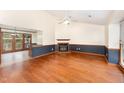 Spacious living room featuring hardwood floors, fireplace, and views of the adjoining dining room at 4705 Matt Dr # B, Raleigh, NC 27604