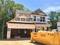 New construction shows two-story home with attached garage, featuring a modern design and durable construction materials at 49 Fetterbush Way, Clayton, NC 27520