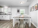 Cozy dining area with a wooden table, four chairs, and ample natural light near the kitchen space at 5310 Gannet Ct, Snow Camp, NC 27349