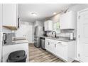 Modern kitchen with stainless steel appliances, white cabinets, and granite countertops offering both style and functionality at 5310 Gannet Ct, Snow Camp, NC 27349