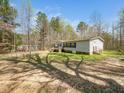 A quaint home with a charming porch nestled within a serene landscape and mature trees at 55 J B Rd, Louisburg, NC 27549